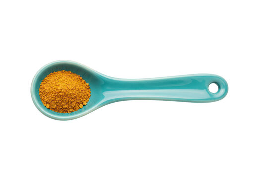 Isolated vibrant turquoise ceramic spoon holding bright orange-yellow spice powder ingredient
