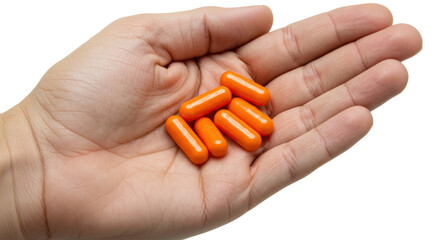 Orange capsules in hand isolated on transparent background, dietary supplement for health and wellness