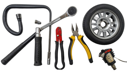 Fototapeta premium Various automotive tools, including a tire and a set of wrenches, are meticulously arranged against a stark black background.