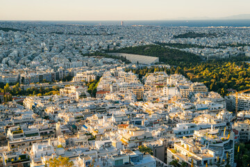 Panoramic view of Athens, Greece from the top of Lycabettus Hill at sunset. The Acropolis can be...