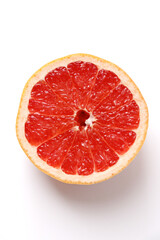 A fresh grapefruit cut in half. The refreshing taste of bright red flesh.