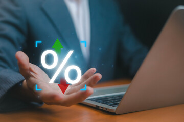 Businessman hand holding glowing percentage icon with up and down arrows, finance interest rate change, economic growth or decline, investment risk, business strategy, inflation, profit.