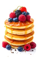 Stack of pancakes topped with berries and syrup