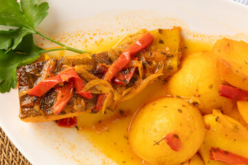Roasted fish fillet with potatoes and peppers