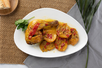 Baked chicken leg with potato and red pepper stew