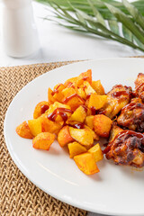 Bbq chicken wings and fried potatoes with ketchup