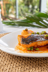 Pan-fried fish fillet with peas and sauce for dinner