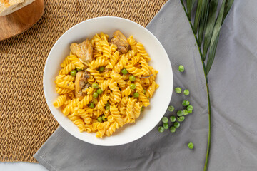 Fusilli pasta with chicken and peas serving