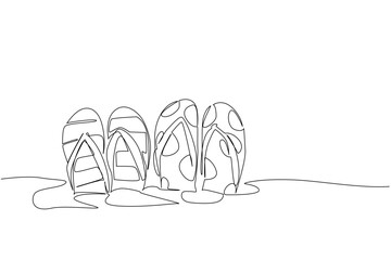 Continuous one line drawing 2 pairs of patterned flip flops embedded in the sand. A young couple spends their holidays on the beach. National Flip Flop Day. Single line draw design vector illustration