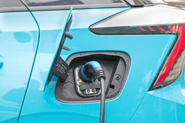 Blue Electric Car Charging at Station