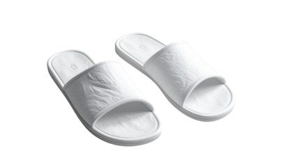 Clean, bright white pair of spa-style slippers sit against a stark black background, showcasing the texture and minimalist design, emphasizing comfort and relaxation through the use of light and...