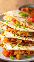 Stacked tortilla-filled wedges on a plate, garnished with greens