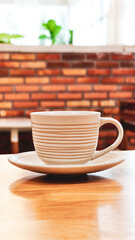 Morning Ritual: A minimalist still life features a ceramic mug with a delicate pattern, resting elegantly on its matching saucer upon a sleek wooden surface, creating a serene moment of daily routine.