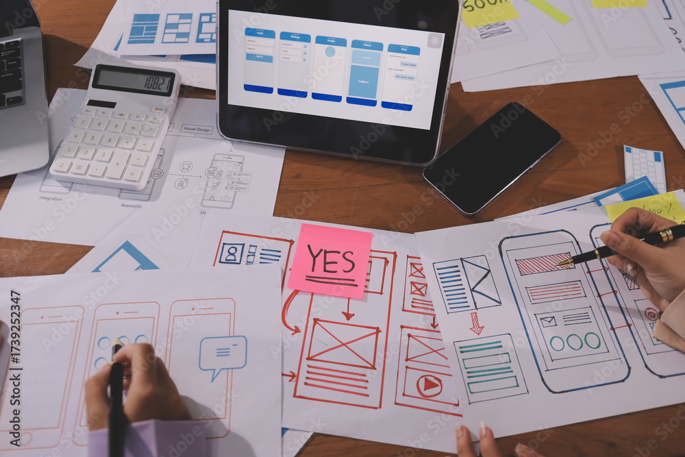 Wall mural close up ux developer and ui designer brainstorming about mobile app interface wireframe design on t
