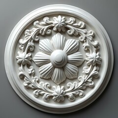 White circular marble ornament features elegant floral and leaf design. It is a decoration with classic aesthetic, ornate pattern, smooth surface, light color. Interior design element, craft item.