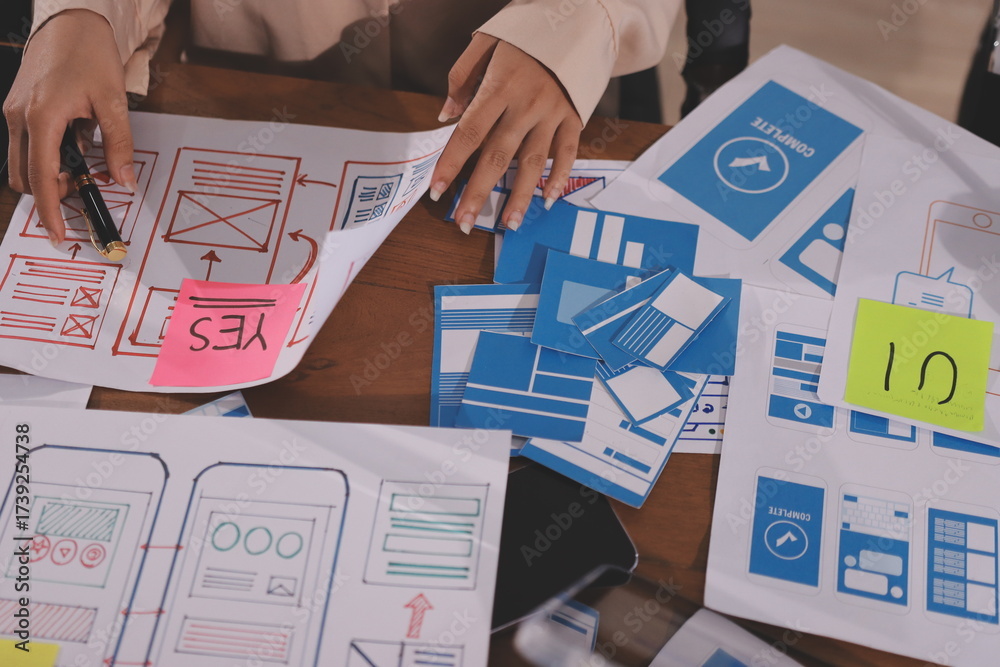 Wall mural close up ux developer and ui designer brainstorming about mobile app interface wireframe design on t