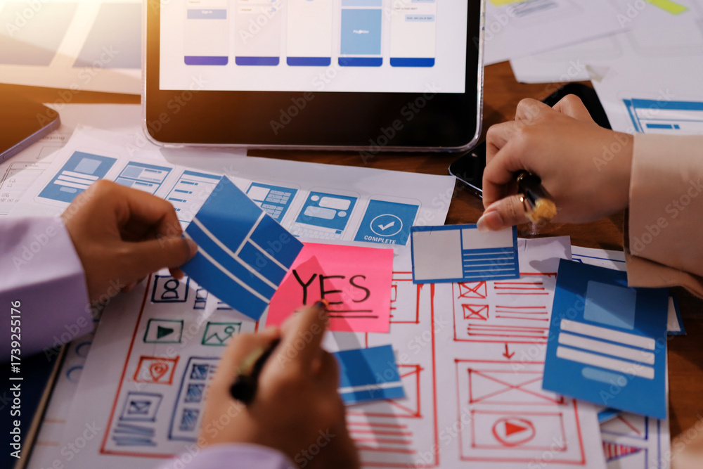 Wall mural close up ux developer and ui designer brainstorming about mobile app interface wireframe design on t