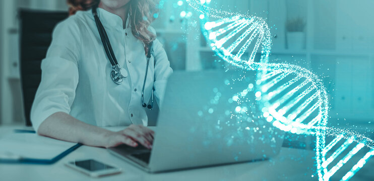 Female doctor with stethoscope using laptop at desk, glowing DNA strand overlay, in clinical office setting. Concept of genetic research and medicine