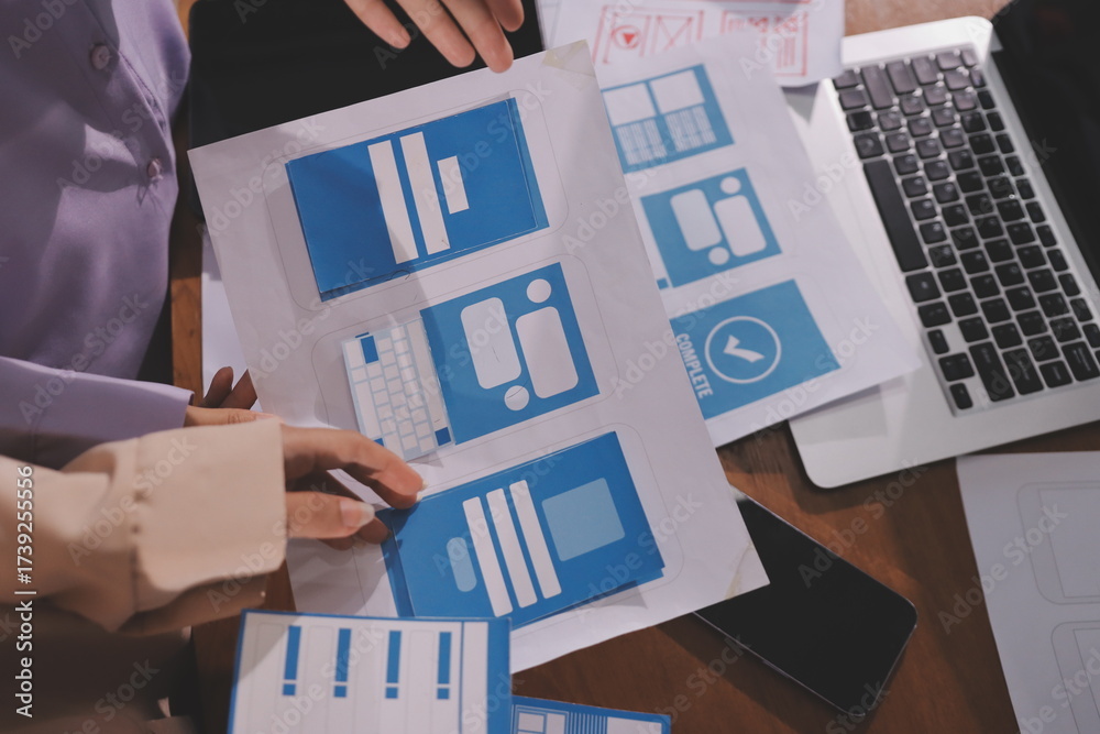 Wall mural close up ux developer and ui designer brainstorming about mobile app interface wireframe design on t
