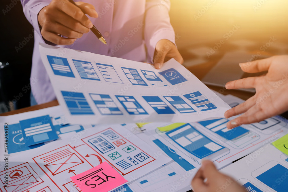 Wall mural close up ux developer and ui designer brainstorming about mobile app interface wireframe design on t