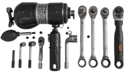 Various mechanical tools and components are arranged on a black background, showcasing an array of ratchets, sockets, and a large industrial instrument, emphasizing equipment and elements of...