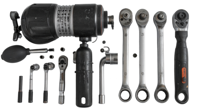 Various mechanical tools and components are arranged on a black background, showcasing an array of ratchets, sockets, and a large industrial instrument, emphasizing equipment and elements of...