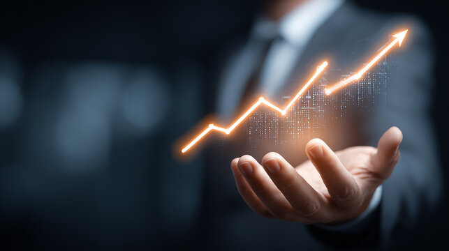 Professional businessman in formal suit holding a glowing digital graph chart with rising trend lines, modern office background, business growth concept - Powered by Adobe