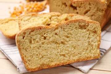Freshly baked cornbread and seeds on wooden table, closeup