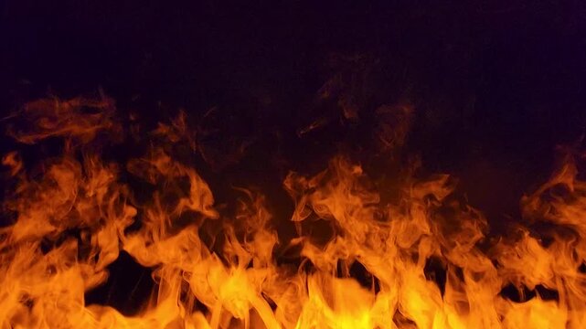 Bright Orange Flames and Fire Wall Texture on Black Background