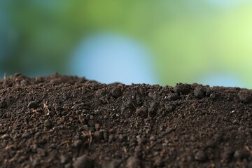 Pile of fresh soil on blurred background, closeup