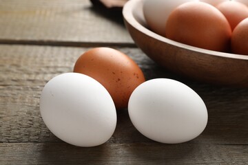 Fresh chicken eggs on wooden table, closeup