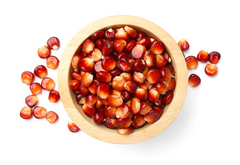 Ripe red corn kernels and bowl isolated on white, top view
