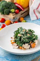 Fresh kale salad with mushrooms, roasted squash, and crunchy nuts
