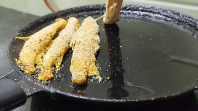 Indian Style Fish Fry Cooking in Hot Oil Pan. Fish Fry on a Frying Pan with Selective Focus.