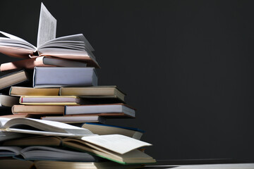 Many books on table against grey background, closeup. Space for text
