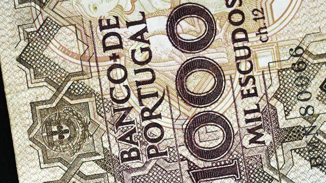 Portugal 1000 Escudos banknote obverse with Banco de Portugal text and figure detail rotating on black background