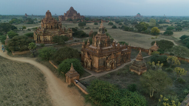 Aerial view of ancient temples and pagodas rise majestically from the Bagan Archaeological Zone, casting long shadows in the soft light of dawn, Old Bagan, Mandalay Region, Myanmar.
