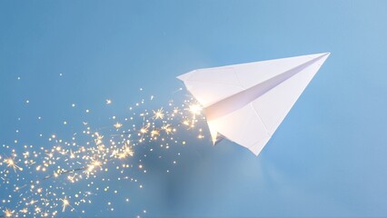 A white paper airplane soars through a clear blue sky, leaving a trail of bright, sparkling embers in its wake.