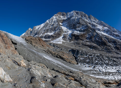Glacier tongue flowing over rugged mountains. View of the anun and langgletscher in Loetschental valley in Valais, Switzerland