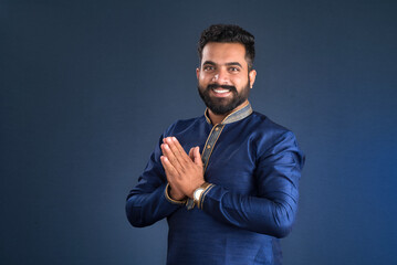 Young Indian man with welcome expression or inviting or greeting Namaste