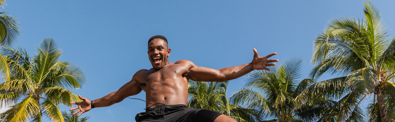 Muscular man embraces the vibrant Miami sun while working out outdoors