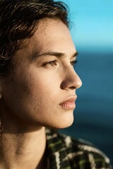 Profile of Young Woman Contemplating Horizon Over Sea