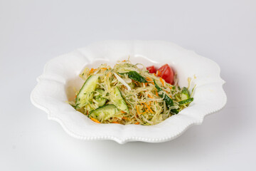 Side view of salad with cabbage, carrots, and cucumbers. Perfect for product ads and packaging.