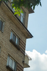 A tall brick building stands proudly against a clear blue sky background