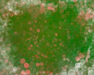 A festive background with bokeh on green. A frame of glowing circles in shades of red, white, and pink on a rich green background. A festive shimmer.