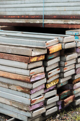 Colorful Metal Panels and Construction Materials Stacked at Building Site