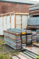 Colorful Metal Panels and Construction Materials Stacked at Building Site