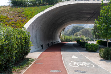 Curved tunnel with bicycle lane and painted road marking in sustainable urban infrastructure symbolizing modern cycling culture and green identity