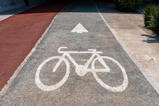 Bicycle lane surface with painted arrow and cycle icon as example of sustainable design, functional clarity and modern urban transport