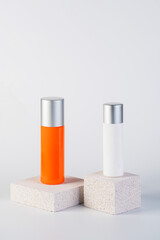 Cosmetic product in tube, bottle, lotion or serum with stylish props on white background. 
